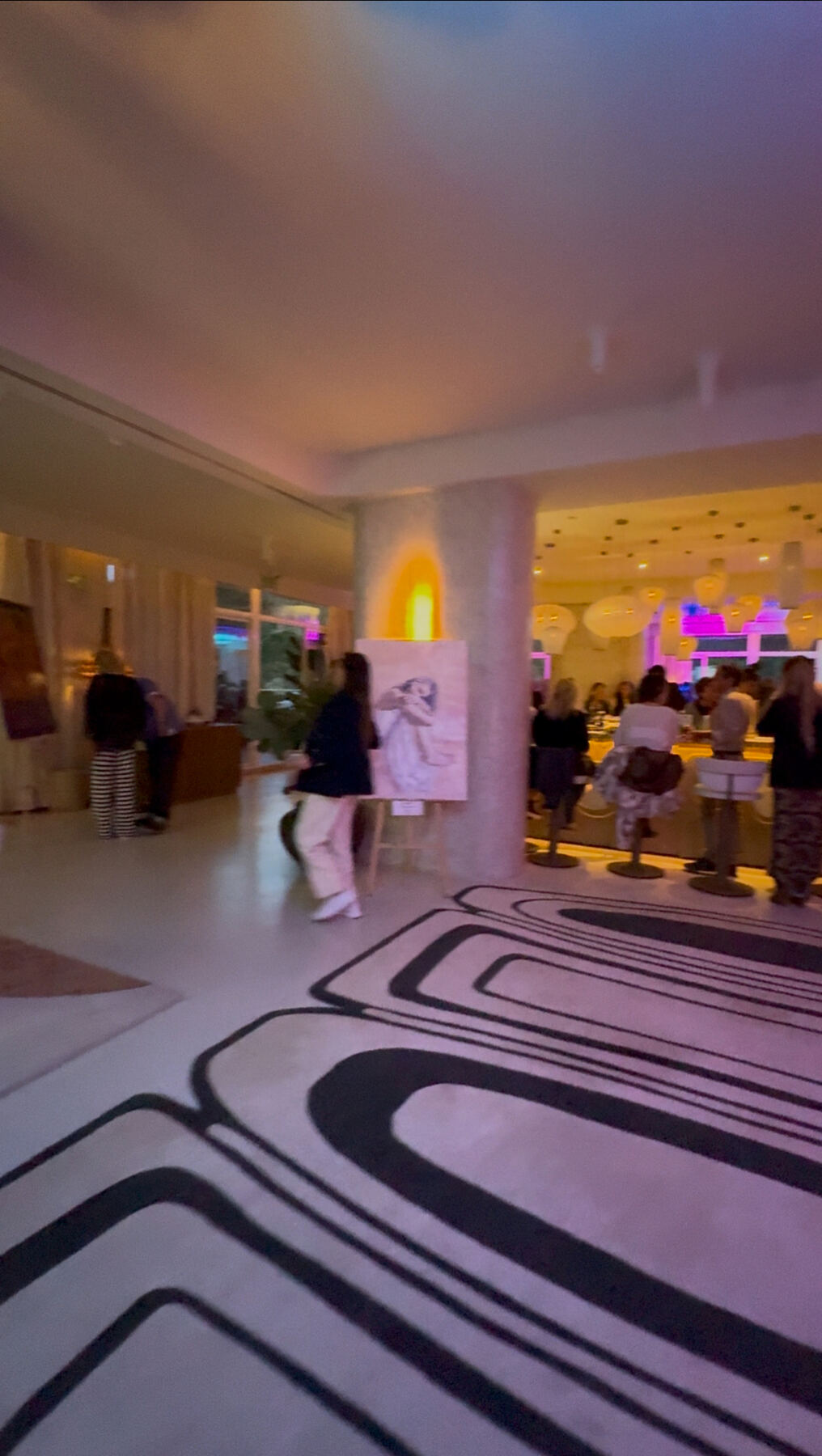 Late-night atmosphere — Mondrian lobby lit in magenta and gold.